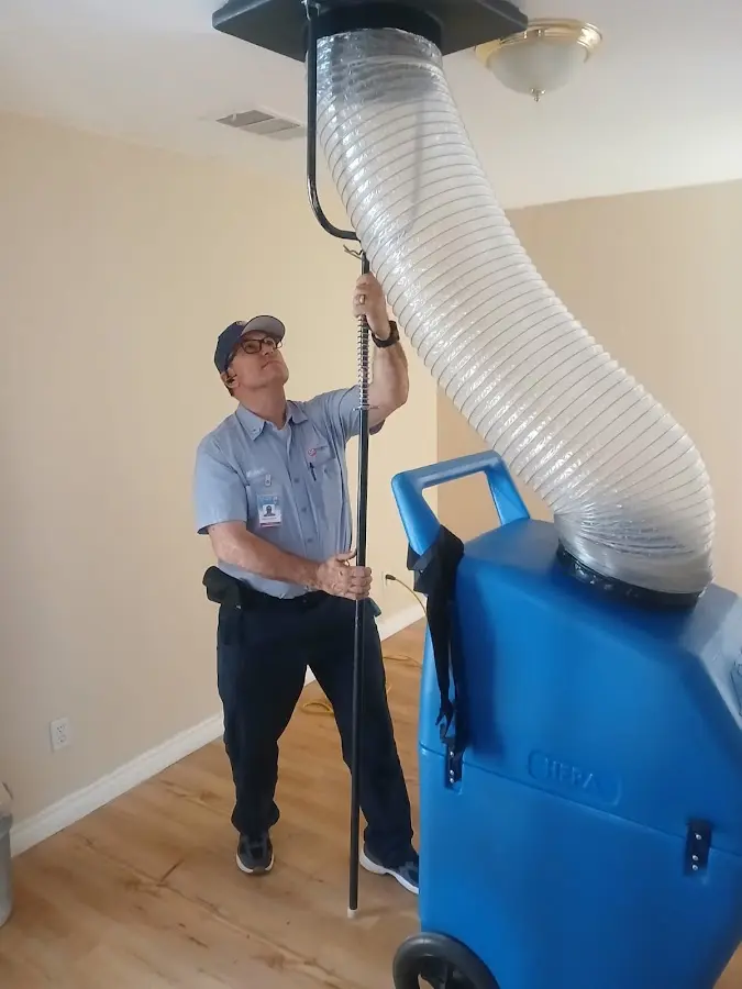 Furnace Tune-Up technician using HEPA equipment in Canby